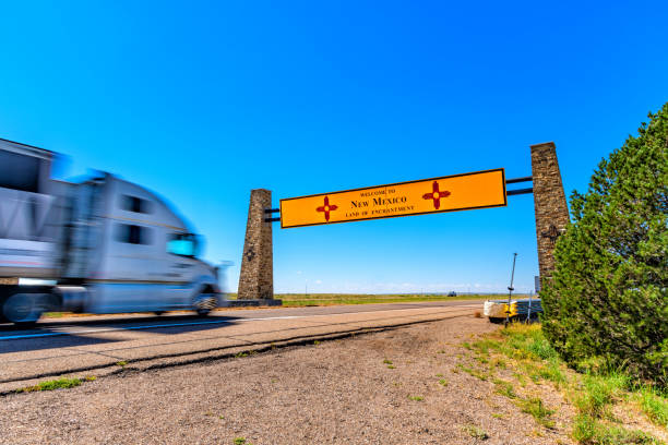 A semi-truck blurred from its speed traveling westbound along Interstate 40 from Texas into New Mexico.