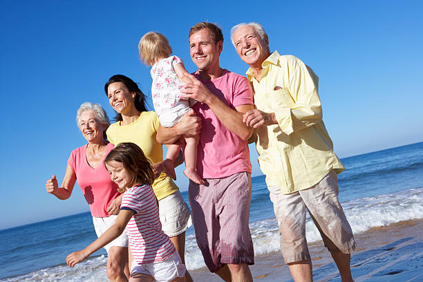 istock Multi Generation Family Running Along Beach Together 171572079