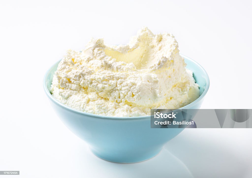 cream cheese in a bowl soft cream cheese with a parsley in a blue ceramic bowl Curd Cheese Stock Photo