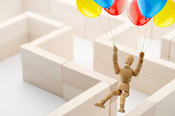 istock wooden mannequin escapes from labyrinth 171572640
