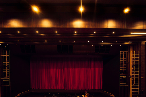 theatre stage with red curtains close