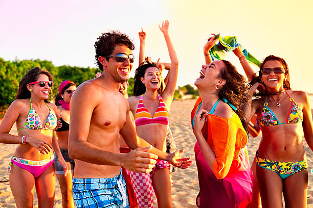Lifestyle of happy young friends group  sitting at the beach