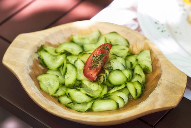 Fresh cucumber salad with tomato slice.