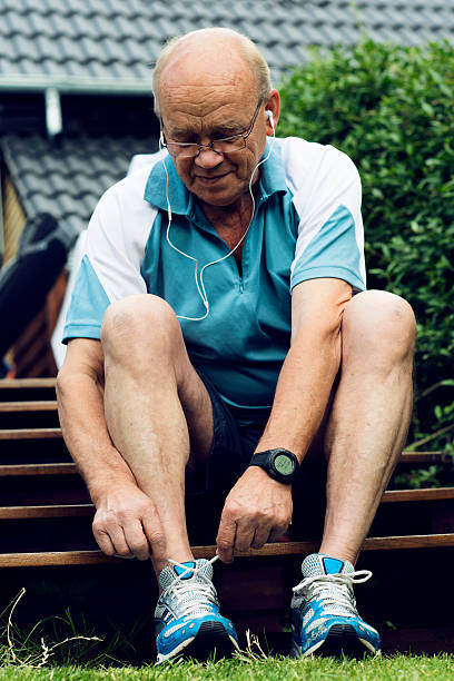 istock Senior man is tying a sports shoe before running 171573484