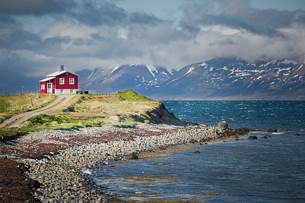 Famous building under the Snaefellsjokull volcano and glacier in Arnarstapi, Snaefellsnes peninsula, Iceland. Dramatic icelandic landscape, lonely house on the volcanic cliffs seacoast. Icelandic