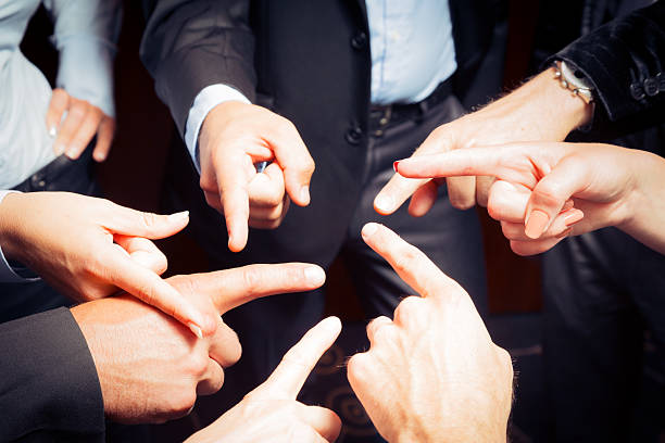 business team blaming each other business team pointing at each other, trying to give the responsibility to someone else. this photo was taken at the pletna'lypse photo event in bled, slovenia. gorenjska stock pictures, royalty-free photos & images