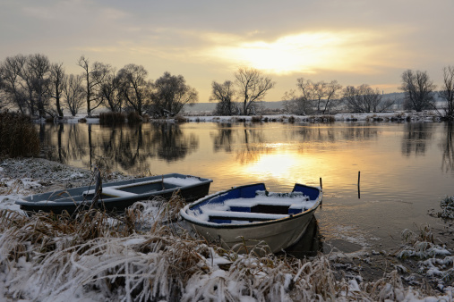 Sunset winter landscape with two boats. Havel River in Brandenburg (Germany). nature reservation \