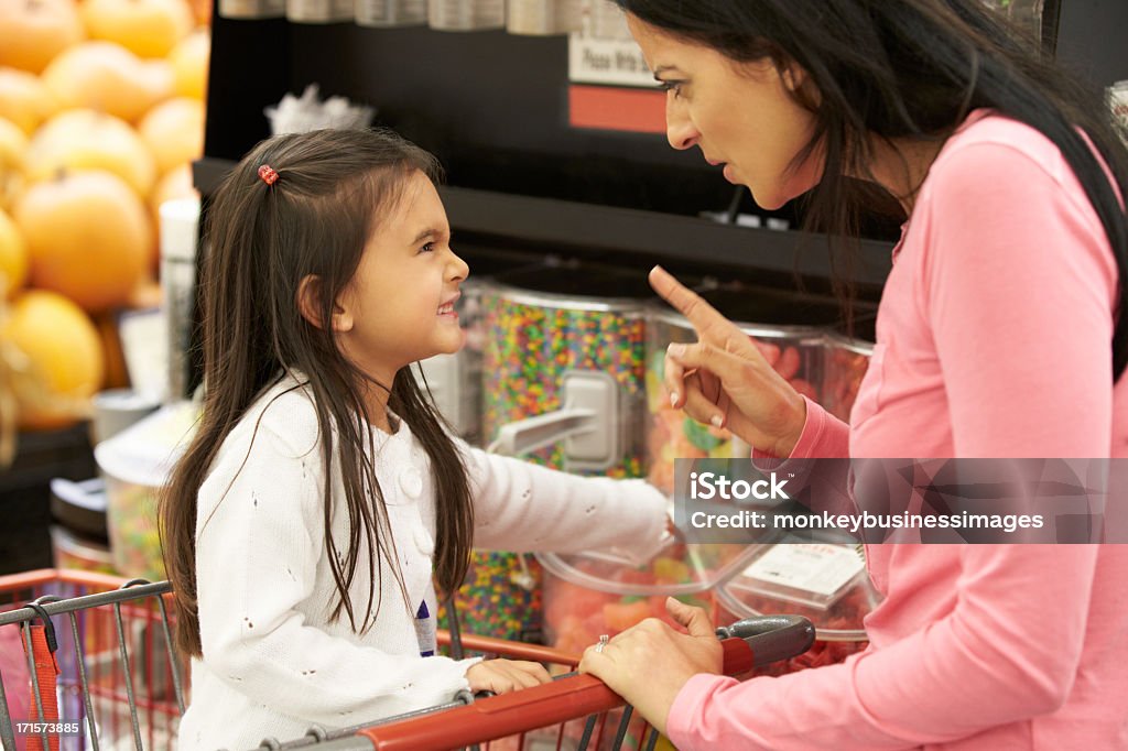 Girl Having Argument With Mother At Candy Counter Girl Having Argument With Mother At Candy Counter In Supermarket Child Stock Photo