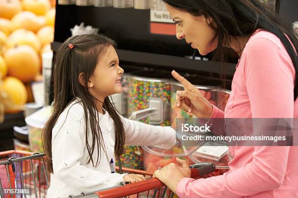 Girl Having Argument With Mother At Candy Counter Stock Photo - Download Image Now - Child, Tantrum, Mother