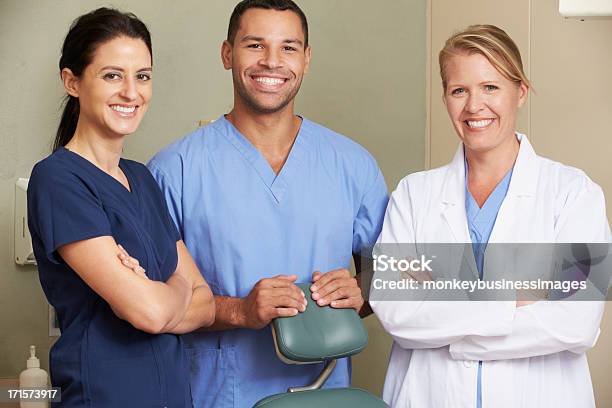 Portrait Of Dentist And Dental Nurses In Surgery Stock Photo - Download Image Now - Dentist, Teamwork, Dental Equipment