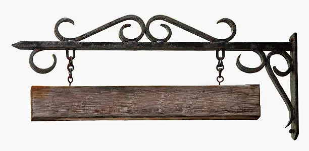 An old black hanging sign made from wrought iron with a blank wooden board hanging from chains.  Isolated on white.