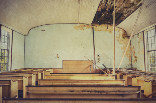 The inside of an abandoned, falling down church. Grungy edit.