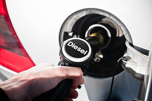 Pumping Gas Fuel pump at Petrol Station. Diesel Pump. diesel fuel photos stock pictures, royalty-free photos & images