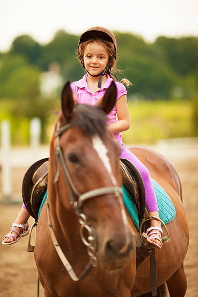 istock Child Riding Horse Outdoors. 171574497