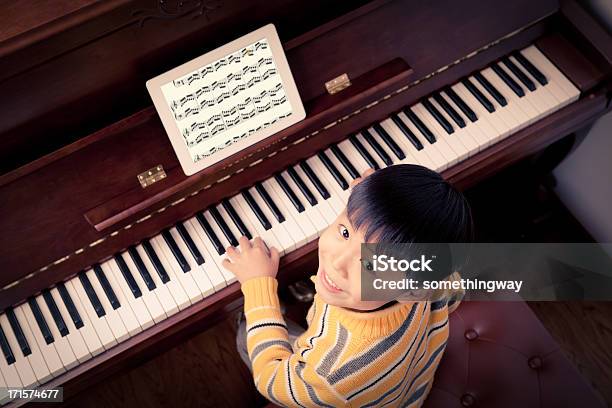 Little Boy Aprender A Jugar Al Piano Foto de stock y más banco de imágenes de Hoja de Partitura - Hoja de Partitura, Nota musical, Tableta digital