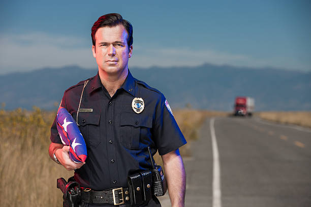 istock Police Officer on Roadway with Flag 171574706