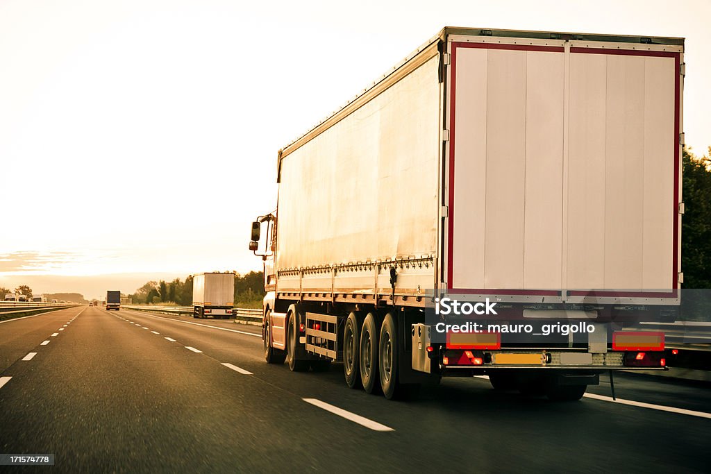 Truck on highway Truck on highway at sunriseLow light at sunrise. Night Stock Photo