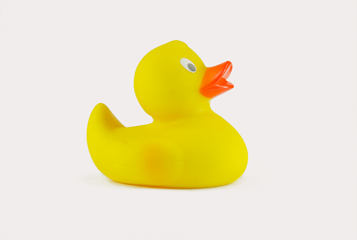 A small yellow rubber duck isolated on a white background.