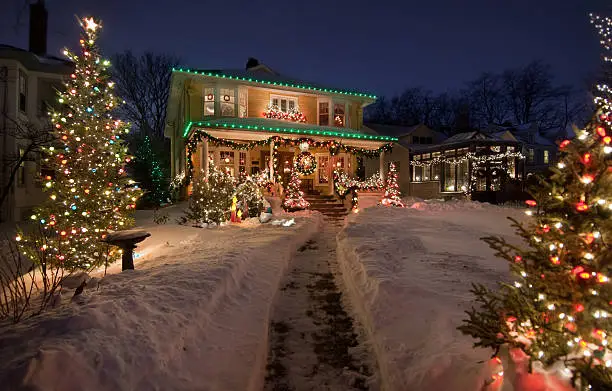 Old Historic Home with christmas lights and snow