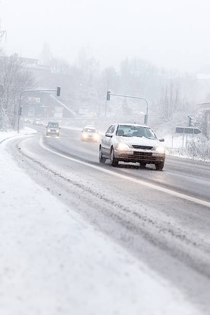 istock Cars on road moving slowly in winter snowfall 171574952