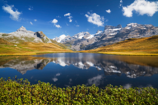 Idyllic mountain lake with Graustock and Titlis at the Melchsee-Frutt, Canton Obwalden, Switzerland.