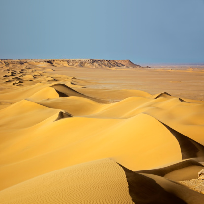 Sand dunes at sunrise in White Desert, Northern Sahara Egypt.
