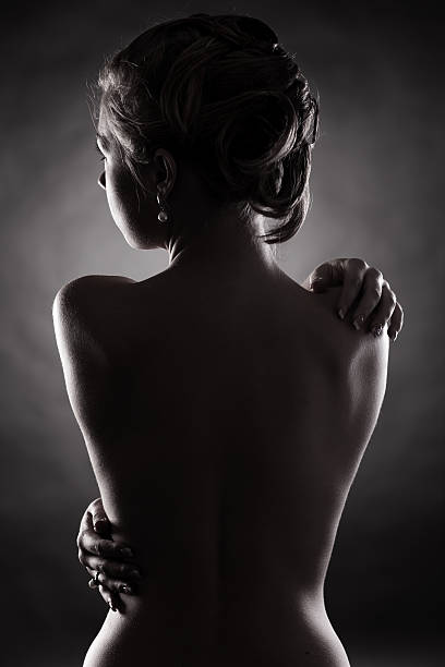 istock nude young woman in the dark 171575370