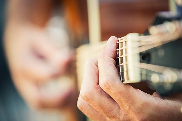 Musician playing guitar stock photo