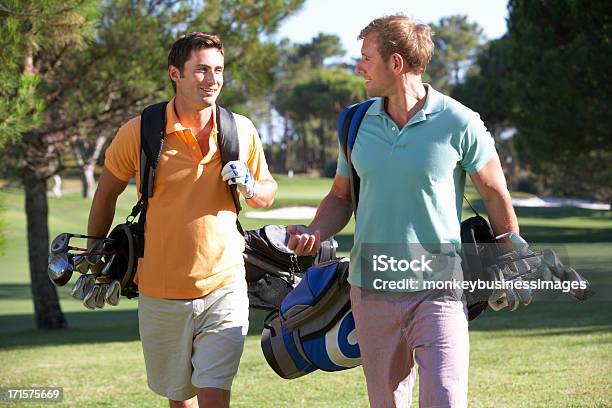 Two Smiling Men With Golf Gear On A Course Stock Photo - Download Image Now - Golf, Golf Club, Men