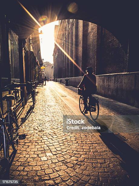 Woman Cycling At Sunrise In Ferrara Italy Stock Photo - Download Image Now - Ferrara, Italy, Cycling