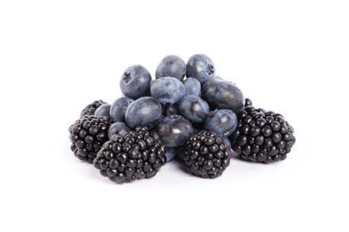 fresh forest fruits:  blueberries and blackberries on white backgroundsee my