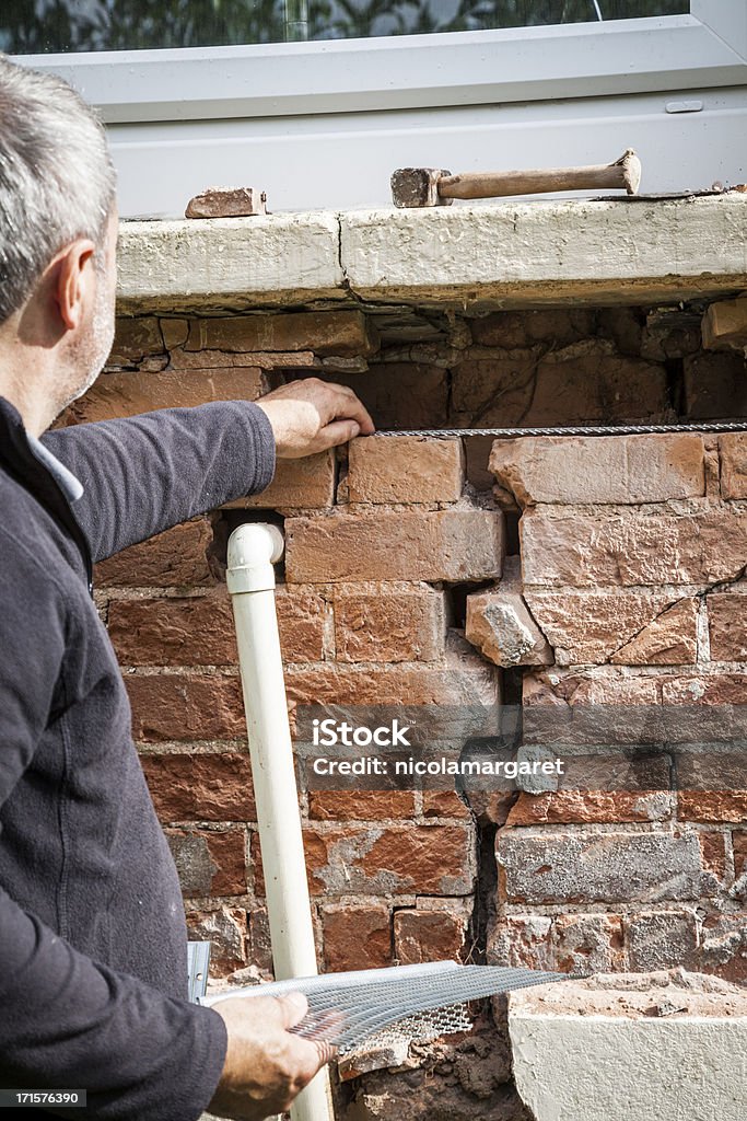 Structural problem: Repairing a cracked wall  Cracked Stock Photo