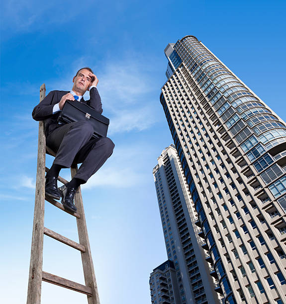 istock Businessman sitting thoughtful on a ladder with briefcase 171576465