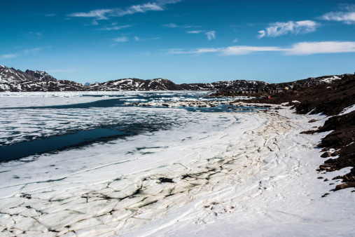 The ice breaking up at the beginning of the summer, with the town of Tasiilaq in the distance, Greenland
