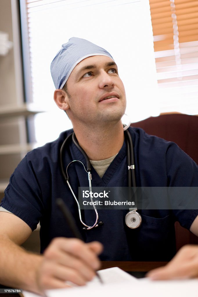 Doctor at his Desk Image of a doctor sitting at his desk. Adult Stock Photo