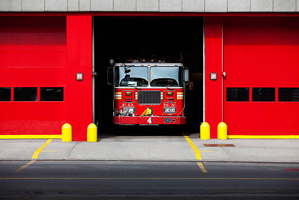 Fire Truck Fire truck parked inside a fire department. New York City.More images from New York: fire station stock pictures, royalty-free photos & images