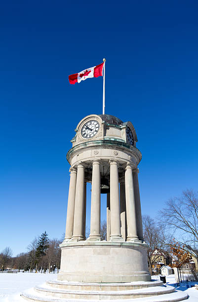 Clock Tower The clock tower in Kitchener's Victoria Park with the Canadian Flag against a brilliant blue sky.Similar Images: kitchener ontario photos stock pictures, royalty-free photos & images