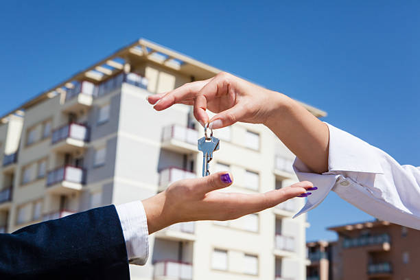 Real Estate Agent giving apartment keys stock photo