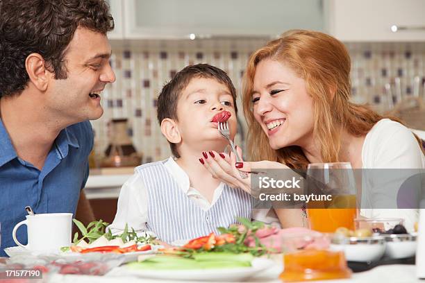 Beautiful Family Of Three Enjoying In The Dinner Stock Photo - Download Image Now - Eating, Family, Salad