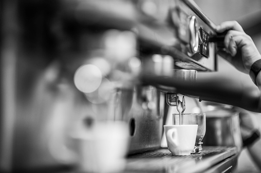 Making  of italian coffee espresso in coffee shop. Black&White image with soft texture to increase a contrast.