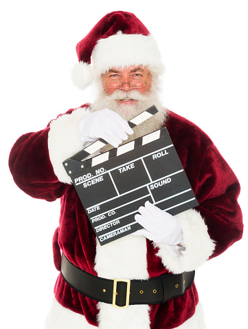 Santa Claus holding a movie slate.