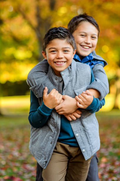 istock Affectionate multiracial brothers playing outside in Autumn leaves 1715774837