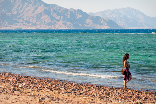 A woman on the shores of the Gulf of Aqaba in Dahab, Egypt