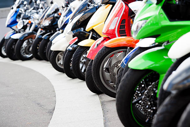 a row of motorbikes parked neatly in a parking lot