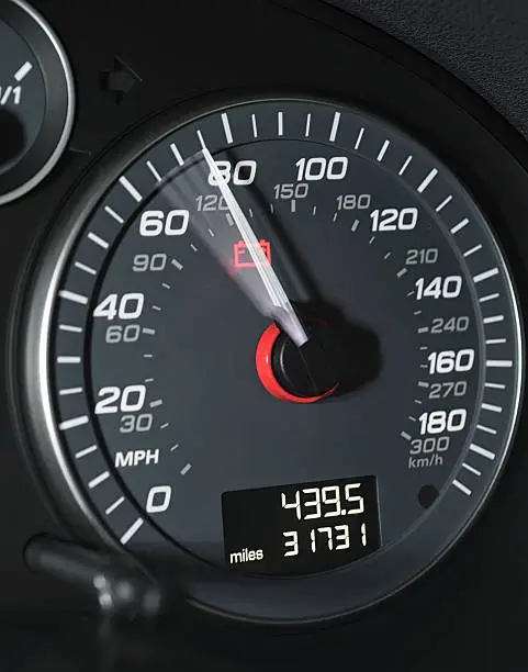 Close-up showing the needle moving past 70mph on a car's speedometer.