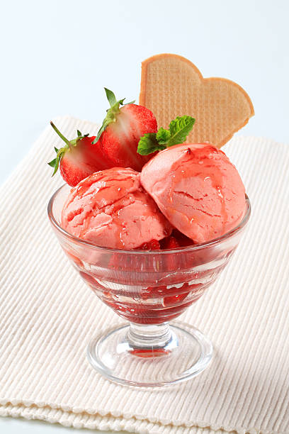 Scoops of strawberry icecream Scoops of strawberry icecream in a glass cup scoop shape photos stock pictures, royalty-free photos & images
