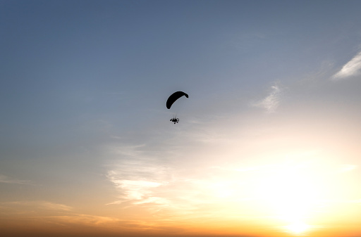 Couple of tourists flying with a motor powered paraglider