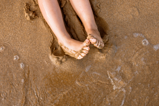 feet standing on the beach