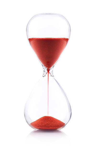 reloj de arena con arena roja sobre fondo blanco-concepto de tiempo - reloj de arena fotografías e imágenes de stock