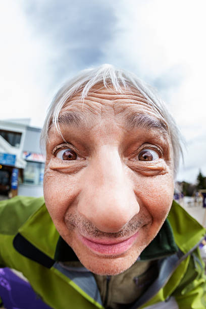 Happy Man Portrait of senior man, with fish-eye lense fisheye lens stock pictures, royalty-free photos & images